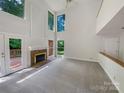 Bright, airy living room with high ceilings, fireplace, and lots of natural light at 9116 Torrence Creek Ct, Huntersville, NC 28078