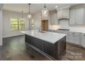 Spacious kitchen featuring a large island with a white countertop, wood floors, and stylish pendant lighting at 104. Wilharr Ct # 40, Mooresville, NC 28115