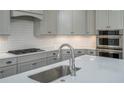 Modern kitchen with gray cabinets, stainless steel appliances, and a white subway tile backsplash at 104. Wilharr Ct # 40, Mooresville, NC 28115