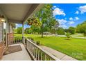 View from covered porch onto a large front lawn and mature shade trees at 117 Ethel Ln, Statesville, NC 28625