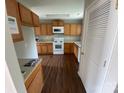 Functional kitchen featuring oak cabinets, modern appliances, and hardwood floors at 118 Steam Engine Dr # 201, Mooresville, NC 28115