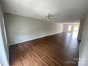 Expansive living room featuring hardwood floors and natural light streaming through the windows at 118 Steam Engine Dr # 201, Mooresville, NC 28115