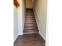 Stairway with modern flooring and white railing leading to the upper level at 118 Steam Engine Dr # 201, Mooresville, NC 28115