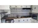 Efficient kitchen with ample counter space, and black and white backsplash at 124 Roxie Ln, Belmont, NC 28012