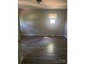 Cozy bedroom featuring wood-look flooring, neutral paint, and a bright window at 1336 Norris Ave, Charlotte, NC 28206