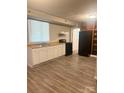 Functional kitchen with white cabinets, black appliances, and new flooring for easy maintenance at 1336 Norris Ave, Charlotte, NC 28206