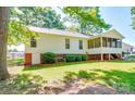 Exterior of home featuring a screened porch addition with white siding and brick foundation at 135 Henry Putnam Dr, Cherryville, NC 28021