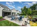 Backyard features outdoor kitchen, fire pit, dining area, and garden at 13602 Huntson Park Ln, Huntersville, NC 28078