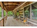 Relaxing covered porch with wooden floors, seating, and a charming rustic ambiance at 140 Hearthstone Dr, Statesville, NC 28677