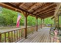 Spacious covered porch with beautiful wood detailing and scenic views of the surrounding greenery at 140 Hearthstone Dr, Statesville, NC 28677