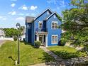 Charming two-story home with a blue exterior, well-maintained lawn, and manicured bushes at 1821 Ethel Guest Ln, Charlotte, NC 28206