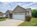 Home featuring a brick-accented two-car garage and well-maintained lawn at 206 Pine Meadow St, Hickory, NC 28601