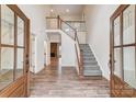 Spacious foyer with wood floors, a staircase, and a view into the living room at 206 Streamwood Rd # 32, Troutman, NC 28166