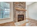 Living room features a stone fireplace, hardwood floors, and large windows for natural light at 206 Streamwood Rd # 32, Troutman, NC 28166