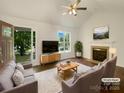 Bright living room featuring a fireplace, hardwood floors, a ceiling fan, and view of the manicured yard at 211 Sherwood Cir, Rock Hill, SC 29730
