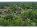 Expansive aerial view of a neighborhood with lush green trees, showcasing a serene and established community at 2213 Milton Rd, Charlotte, NC 28215