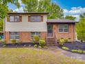 Inviting two-story home with brick and siding, featuring well-maintained landscaping and a cozy entrance at 2213 Milton Rd, Charlotte, NC 28215