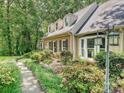 A view of the home's exterior and the walkway with beautiful landscaping at 2437 Woodleigh Dr, Gastonia, NC 28056
