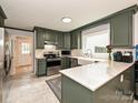 Modern kitchen with stainless steel appliances, green cabinets, and marble countertops at 2437 Woodleigh Dr, Gastonia, NC 28056