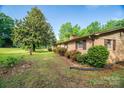 Brick home with manicured shrubs and an expansive lawn at 2871 Loviee Rd, Lincolnton, NC 28092