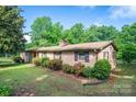 Charming brick home featuring well-maintained landscaping and a lush green lawn at 2871 Loviee Rd, Lincolnton, NC 28092