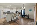 Well-lit kitchen featuring white cabinets, dark appliances, and bar stool seating at 2922 Patishall Ln, Charlotte, NC 28214