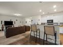 Spacious open-concept living room and kitchen with modern bar seating at 2922 Patishall Ln, Charlotte, NC 28214