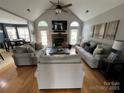 Inviting living room with a cozy fireplace, vaulted ceiling, and bright natural light at 334 River Birch Cir, Mooresville, NC 28115