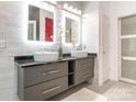 Modern bathroom featuring dual sinks, sleek gray cabinets, and stylish lighting at 3626 Cole Mill Rd, Charlotte, NC 28270