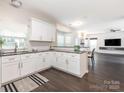 Bright, open kitchen with white cabinets, granite countertops, and stainless steel appliances at 3626 Cole Mill Rd, Charlotte, NC 28270