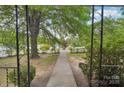 A view of the front yard and sidewalk looking out from the front porch at 409 Rosemont Ave, Kannapolis, NC 28081