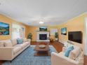 Bright living room features a fireplace, hardwood floors, neutral paint and ample space for entertaining guests at 4325 Wolf Pond Rd, Monroe, NC 28112