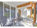 Inviting front porch with rocking chairs and wooden beams, perfect for relaxing at 518 Maynard Farm Ln, Stanley, NC 28164