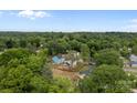 Bird's eye view of a neighborhood surrounded by lush greenery, showcasing a peaceful residential setting at 522 Herms Ave, Mount Holly, NC 28120