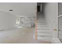 Spacious open-concept area with stairs and a kitchen under construction, ready for customization at 522 Herms Ave, Mount Holly, NC 28120