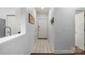 Bright hallway with tile flooring, neutral paint, and a clean aesthetic at 5730 Closeburn Rd # H, Charlotte, NC 28210