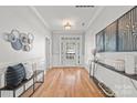 Elegant foyer with hardwood floors, wainscoting, decorative art, and natural light at 6424 Chadwell Ct, Fort Mill, SC 29707