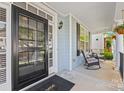 Inviting front porch with rocking chairs and hanging flower baskets, offering a relaxing outdoor space at 6424 Chadwell Ct, Fort Mill, SC 29707