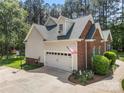 Spacious two-car garage with brick and siding exterior and basketball hoop at 6990 Ridgeway Rd, Stanley, NC 28164