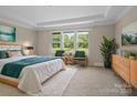 Bright bedroom with a tray ceiling, a large window and stylish decor at 709 Cavesson Way, Monroe, NC 28110