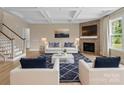 Inviting living room with a coffered ceiling, fireplace, and stylish furniture at 709 Cavesson Way, Monroe, NC 28110