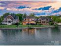Spacious backyard view of waterfront homes, with well-kept lawns and private access to the lake at 7220 Swansea Ln, Cornelius, NC 28031