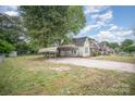 Spacious yard with gravel parking and car port on this charming home's exterior at 813 S Ridge Ave, Kannapolis, NC 28083