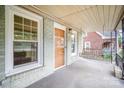 Inviting porch with swing, showcasing the front door and windows of the home at 813 S Ridge Ave, Kannapolis, NC 28083