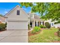 Attractive two-story home with stone accents, well-manicured lawn, and a spacious two-car garage at 8938 Kestral Ridge Dr, Charlotte, NC 28269