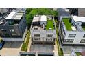 Stunning aerial view of modern home with rooftop deck, green space, and multiple outdoor lounge areas at 945 Westbrook Dr # A, Charlotte, NC 28202