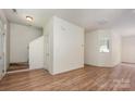 Spacious, light-filled living room featuring wood floors and staircase access at 10016 Lawing School Rd, Charlotte, NC 28214