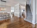 Inviting entryway with hardwood floors, staircase, dining room, and living room at 104 Steamboat Dr, Mount Holly, NC 28120