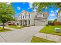 Attractive two-story house featuring a spacious driveway, two-car garage, and neatly landscaped yard at 10906 Charmont Pl, Huntersville, NC 28078