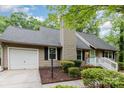 A cozy single-story house boasts a well-maintained lawn, neutral siding, and a convenient attached garage at 11102 Sundown Ln, Charlotte, NC 28226